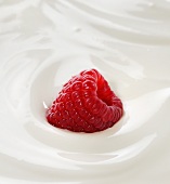 A raspberry in yoghurt (close-up)