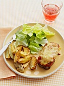 Steak topped with ham and parmesan and grilled, served with potato wedges