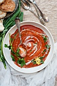 Creamy tomato and pepper soup with crème fraîche and parsley