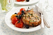 Pork chop with black olives and cherry tomatoes