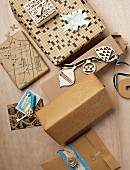 Presents wrapped in warm shades of brown; paper made from old crossword puzzles, printed with miniature stamps and decorated with painted outlines of keys