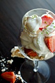 Strawberry dessert with whipped cream, meringue and lime zest