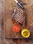Grilled steak with grilled tomatoes and mustard