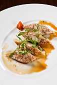 Pork Gyoza on a White Plate with Sauce and Greens