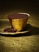 Chocolate sauce in a gold cup