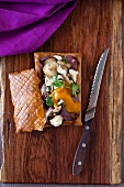 Puff pastry slice filled with vegetables, mushrooms and feta, with yellow tomato sauce
