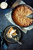 Apple crumble cake in a cake tin and on a plate