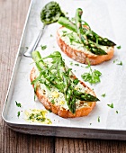 Bruschetta topped with asparagus and rocket