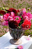 Summer bouquet of dahlias and heather on garden chair