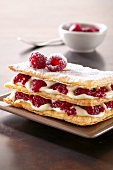 Slices of puff pastry layered with cream and raspberries