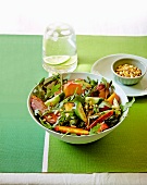A salad of duck breast, peaches, rocket, cucumber and pine nuts