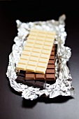 Three bars of chocolate (white chocolate, milk chocolate, dark chocolate)