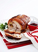 Rolled roasted turkey joint with macadamia and cranberry filling