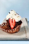 Half a chocolate cupcake with strawberry filling