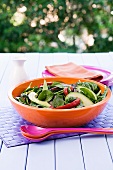 Spinach salad with fried vegetables and avocado