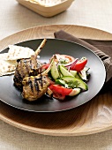 Grilled lamb chops with vegetable salad and flatbread