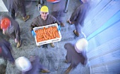 A worker holding a crate of smoked salmon in the factory