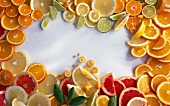 Sliced citrus fruits arranged around the edge of the image