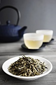 Loose Green Tea, Two Cups of Tea and Japanese Teapot, selective focus