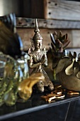 Bronze statue of a kneeling Buddha on table