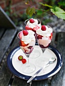 Knickerbocker glory with strawberry ice cream, fresh berries and whipped cream