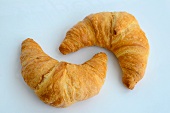 Two croissants against a white background