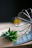 Rosemary, an egg whisk and a knife