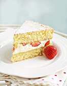 A slice of sponge cake with strawberries