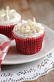 Cupcakes topped with vanilla cream icing and white chocolate stars