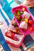 Rice paper parcels filled with strawberries for a picnic