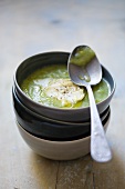Cream of courgette soup in stacked bowls
