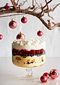 A Christmas trifle with custard cream, berries and fruit jelly