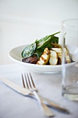 Soy Braised Pork Cheek with Grilled Apples and Spinach; In a White Bowl