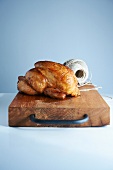Rotisserie Chicken on a Cutting Board; Roll of Twine