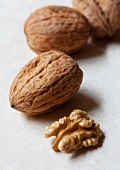 Four unshelled walnuts and one shelled walnut