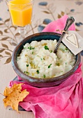 A Bowl of Mashed Turnips with Truffle Oil and Parsley; Spoon