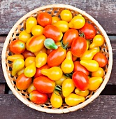 Pear and Grape Tomatoes in a Basket; From Above