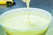 Truffles being coated in white chocolate