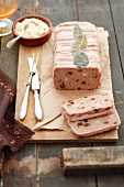 Meat terrine with raisins, wrapped in bacon