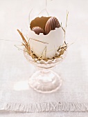 An Easter nest in an eggcup with sweets