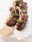 Date skewers with dry-cured ham and almonds