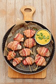 Pork fillet wrapped in bacon with peanut curry sauce and corn