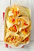 Pancakes filled with chicken, peppers and pineapple, in garlic sauce