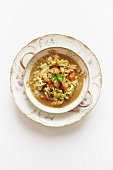 A Bowl of Curry Chicken and Vegetable Soup with Barley