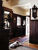 Entryway in a country home with dark wood paneling