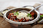 Chicken chilli with sour cream and grated cheese