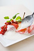 Red pears with vanilla foam and redcurrants