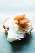 Bread topped with wafer-thin slices of cheese, with quince jelly