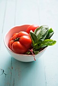 Tomatoes and fresh basil in a small bowl