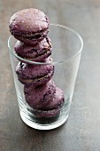 Purple macaroons, stacked in a glass